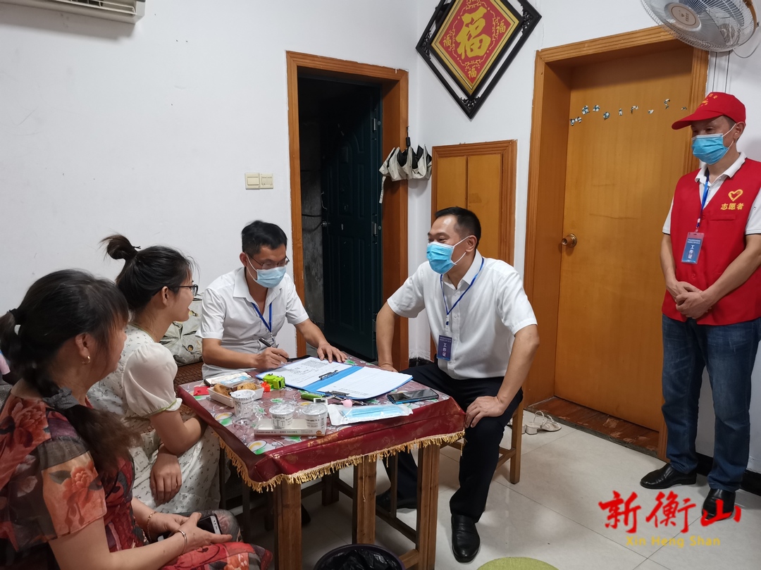 段晓赛为居民张贴“全员接种示范家庭”标牌